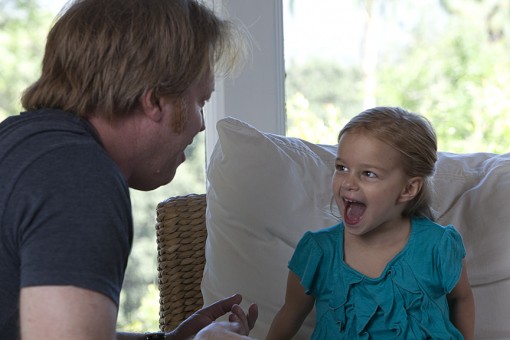 director Greg McDonald working with child actor in a behind the scenes shot