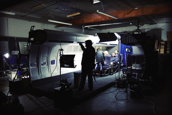 behind the scenes on an airplane set for a travel product
