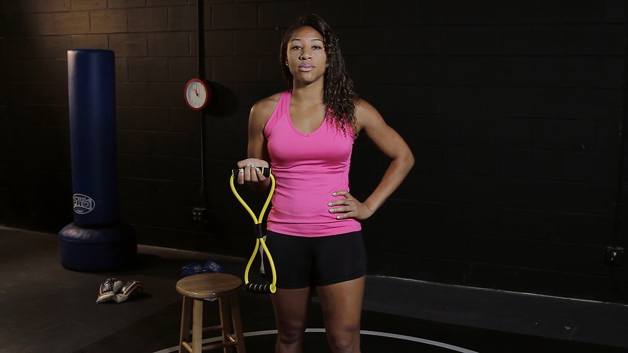 fitness trainer teaches exercise in gym in a workout video production