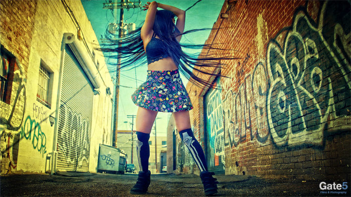 colorful photo fashion model in alley with graffiti hollywood