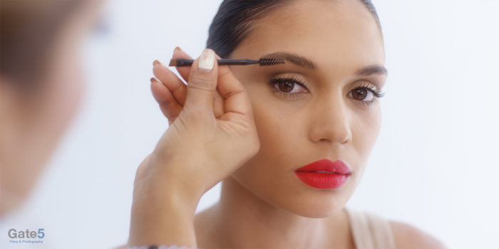 behind the scenes beautiful model gets eye brows done