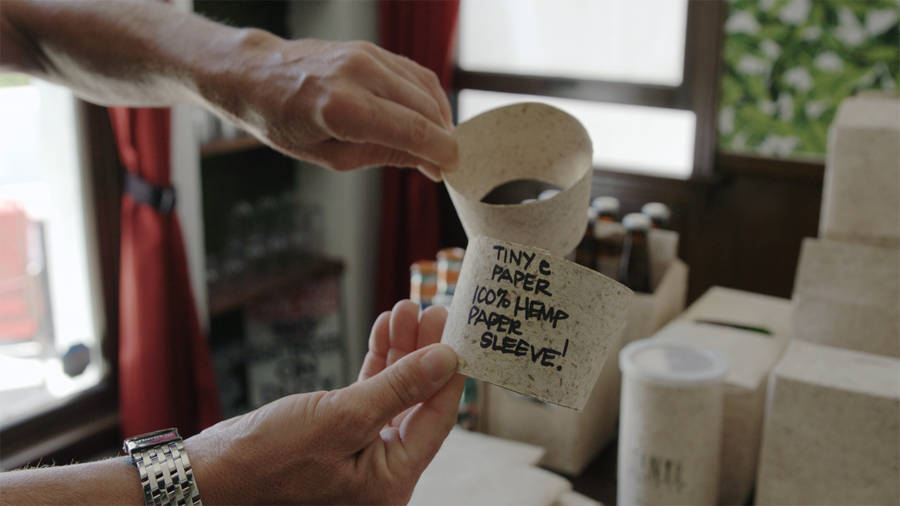 close up of a coffee sleeve made from hemp paper in an episode of a video series on hemp