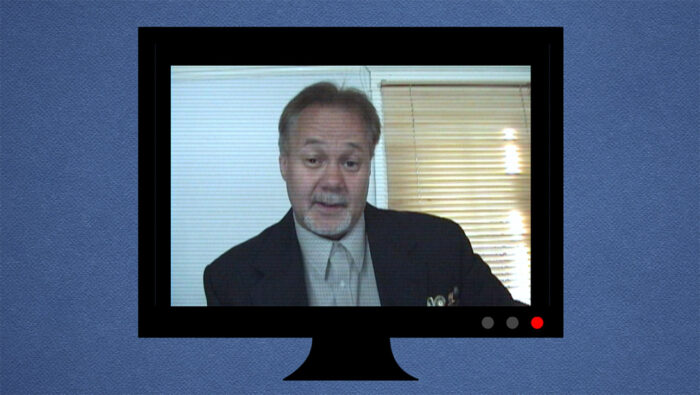 a business man on a screen in a video conference call