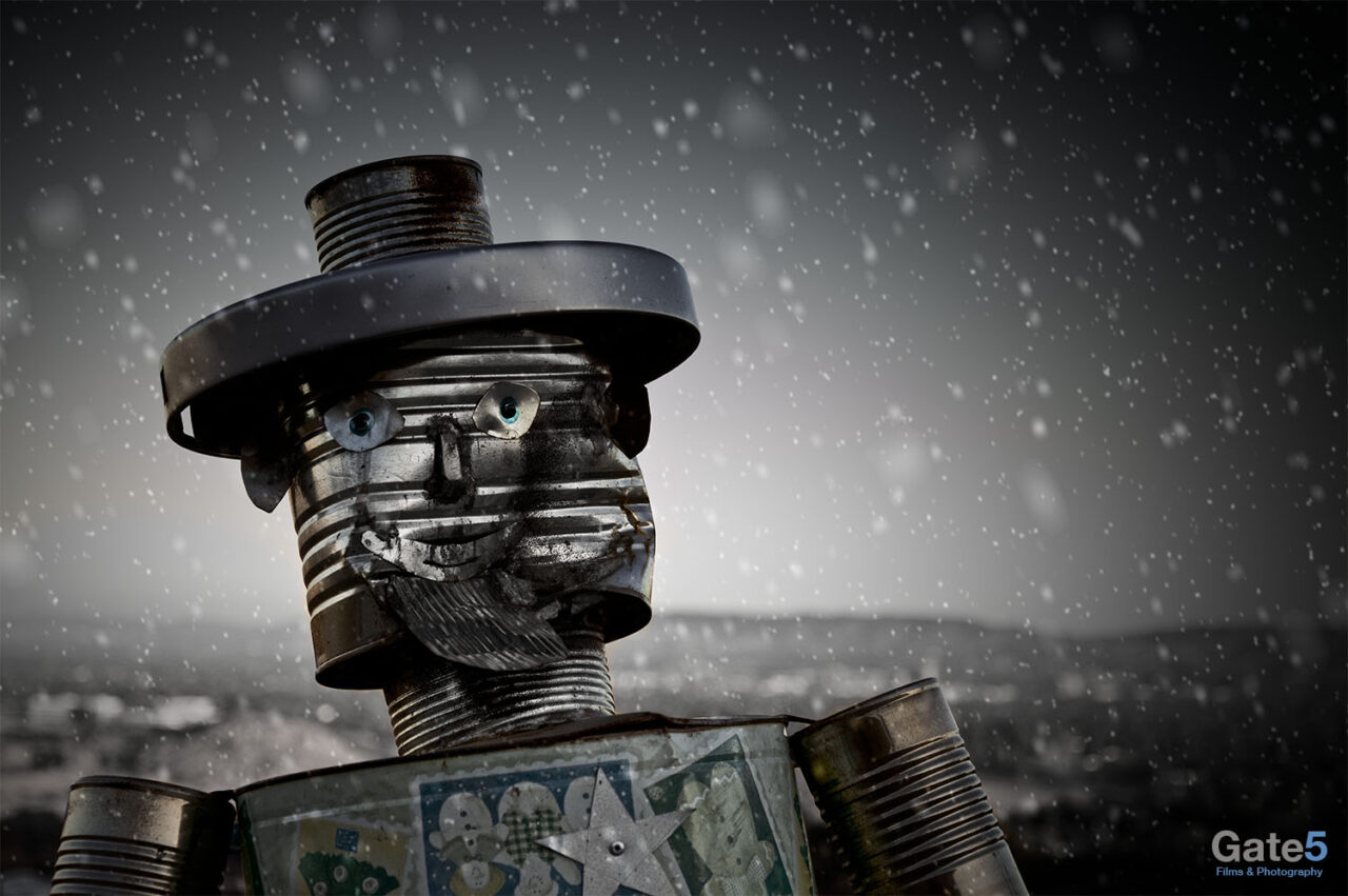 artistic photograph of f statue of a man made out of tin cans and other junk